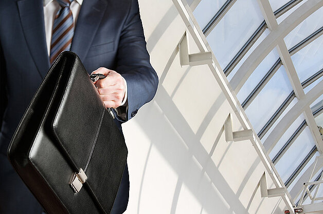 security guard holding suitcase